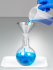 Pouring Blue Liquid Into a Burkle Stainless Steel Funnel