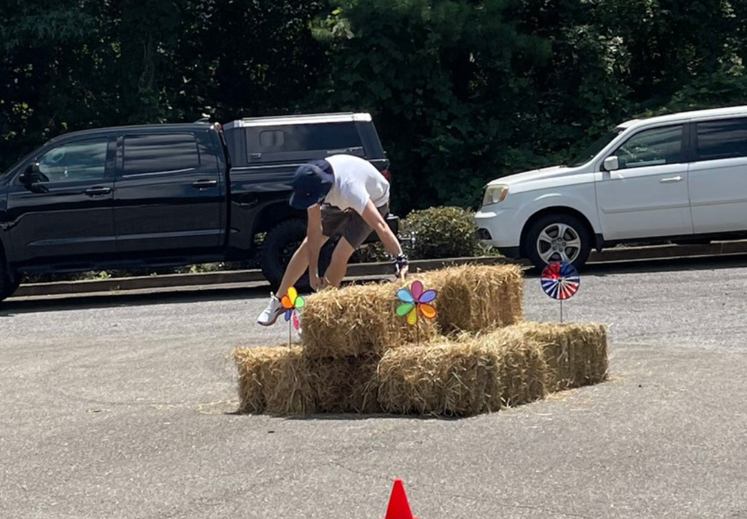 Matt Climbing Over Haybales